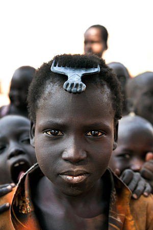 South Sudanese girl with a comb, her only possession